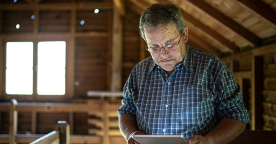 man in attic with tablet